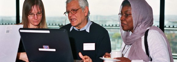 Lasa staff member demonstrating showing Lasa's Multikulti website to two guests at Lasa 21st anniversary event